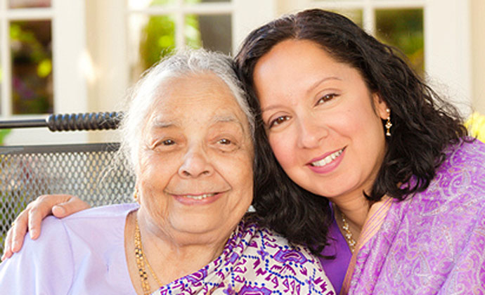 Female caregiver posing with her mother