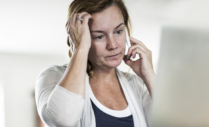 A grieving woman talks on the phone