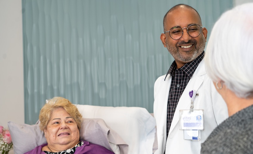 A doctor converses with patients.